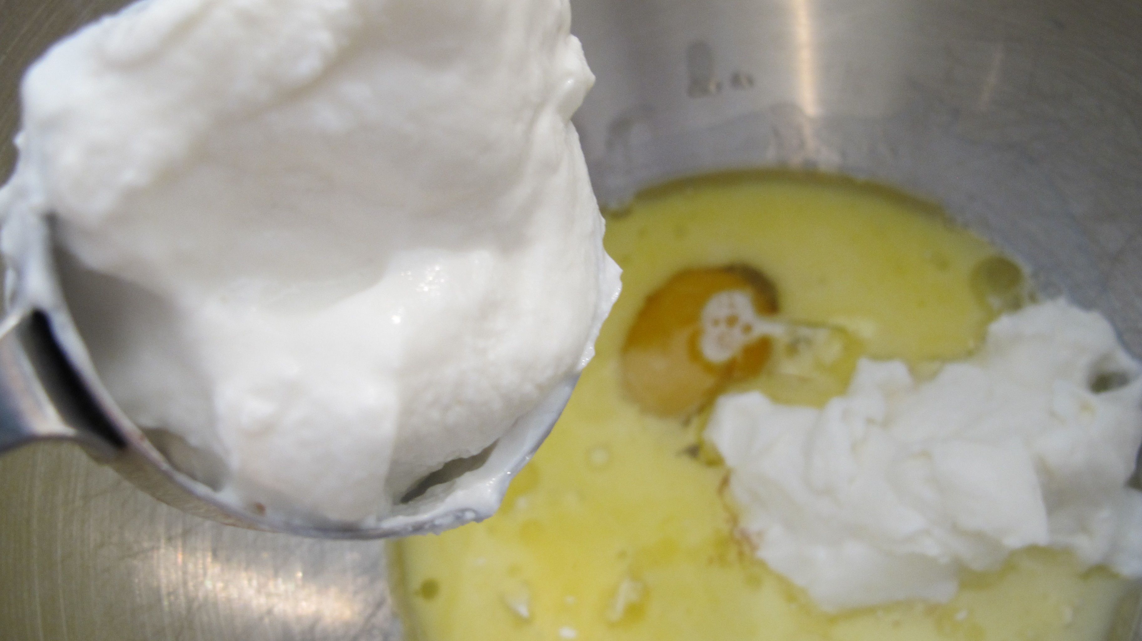 Adding fresh Greek Yogurt to the wet mixture. 