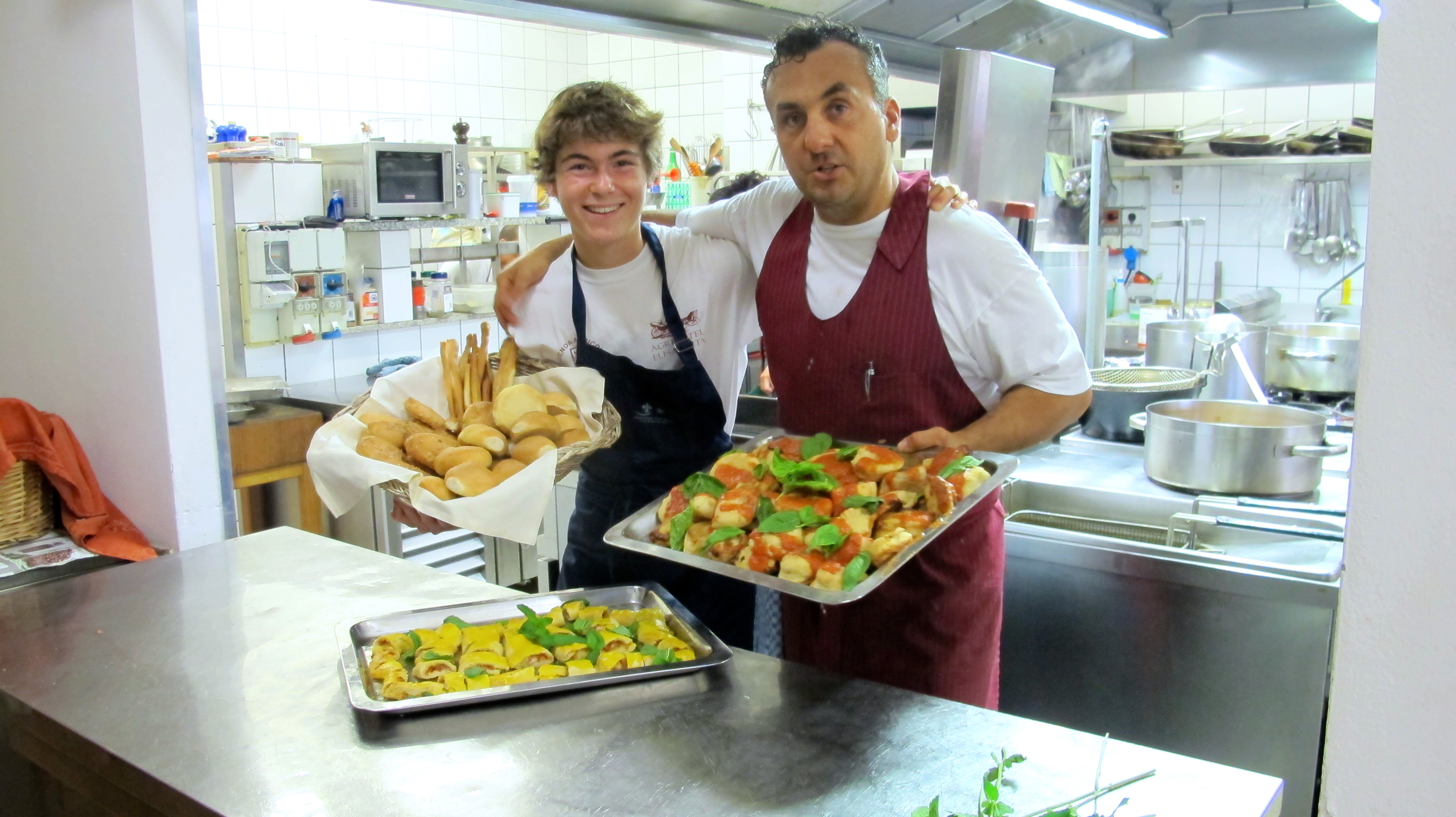 Leonardo, the Head Chef, and I holding a day's worth of creative bread work to be placed on the buffet table.