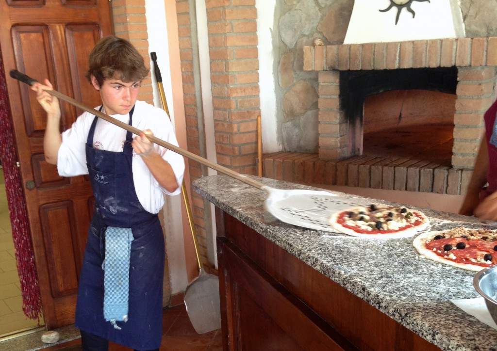 16 years old, and working the pizza oven at the Agrihotel Elisabetta. 