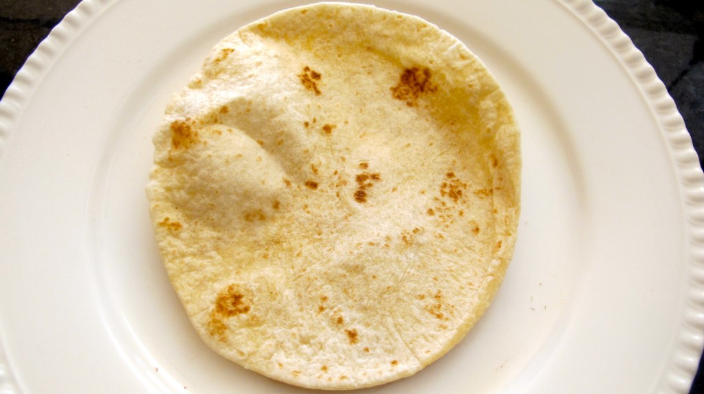 Start with a tortilla flat on the plate. 