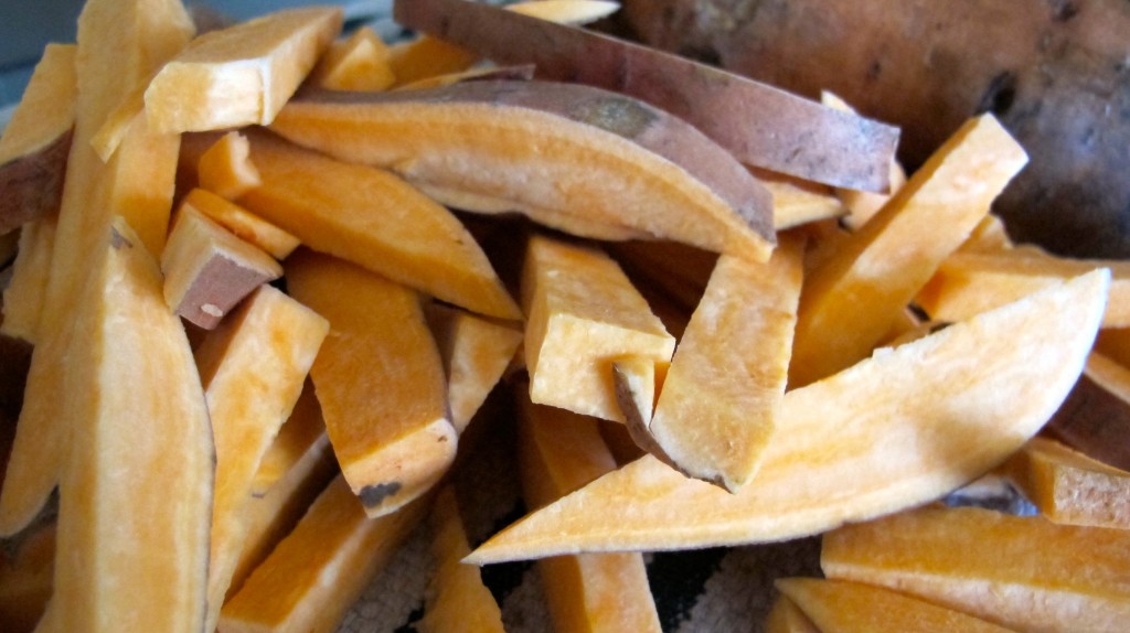 The raw, thin fries cut for roasting. 