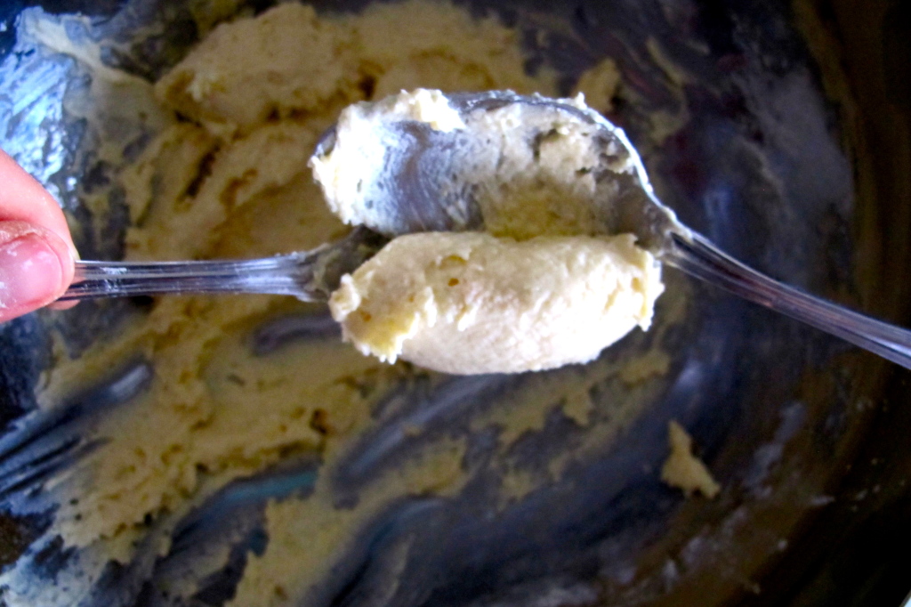 The quenelle technique. Scoop the gnudi from one spoon to the other about six or seven times over. 